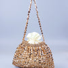 A handmade dumpling bag made of gold and silver beads with a delicate, beaded handle.