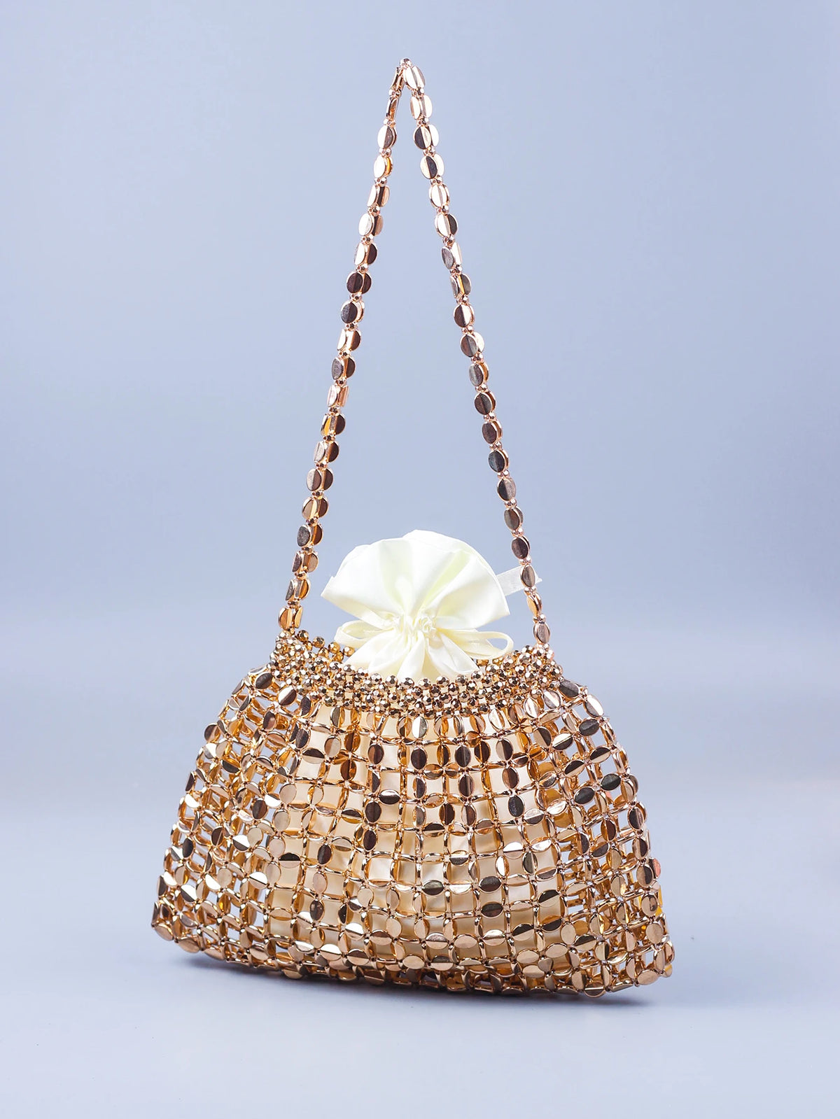 A handmade dumpling bag made of gold and silver beads with a delicate, beaded handle.