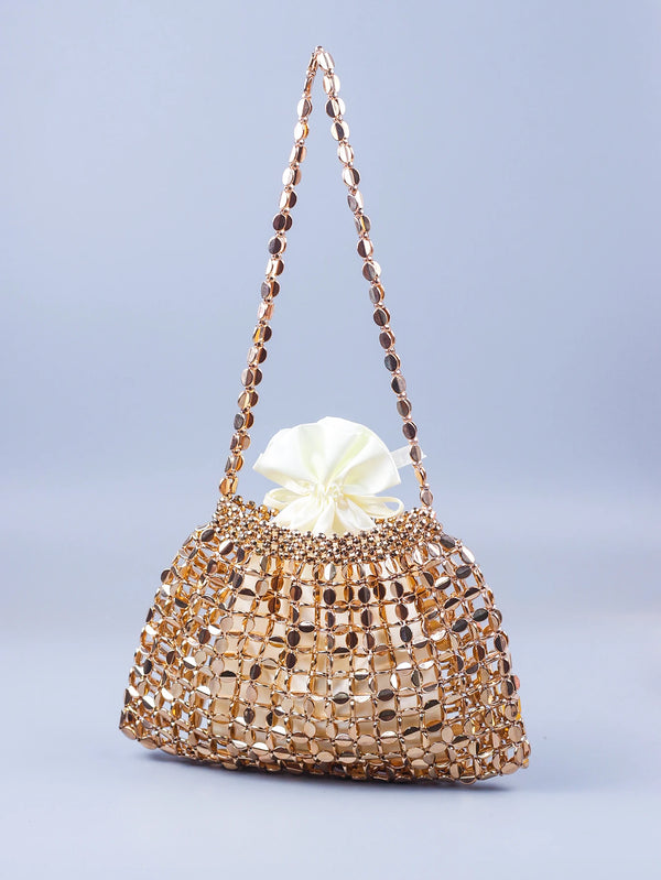 A handmade dumpling bag made of gold and silver beads with a delicate, beaded handle.