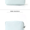 A light blue and white striped cosmetic bag with a zipper closure.