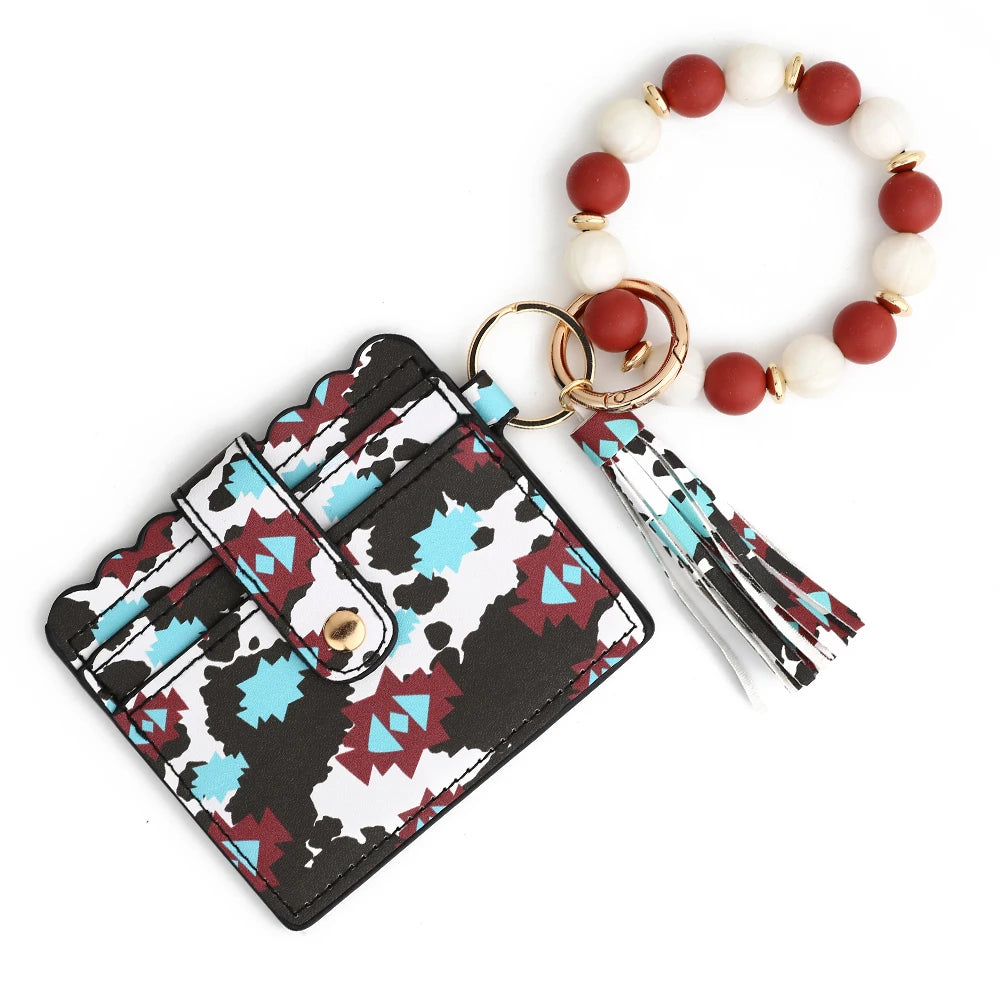 A silicone bead and leather card wallet featuring a black and white patterned cover and a beaded bracelet.
