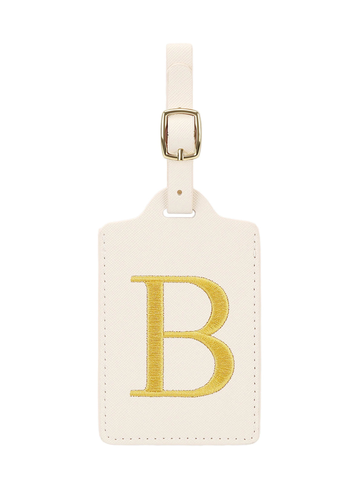 Étiquette de bagage en cuir crème avec une lettre B brodée en or et un clip métallique argenté.