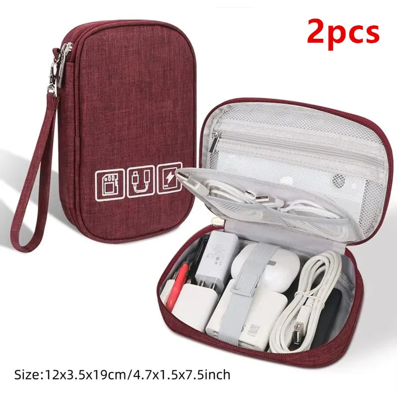 A maroon portable digital organizer storage pouch with a zippered compartment containing various electronic accessories.