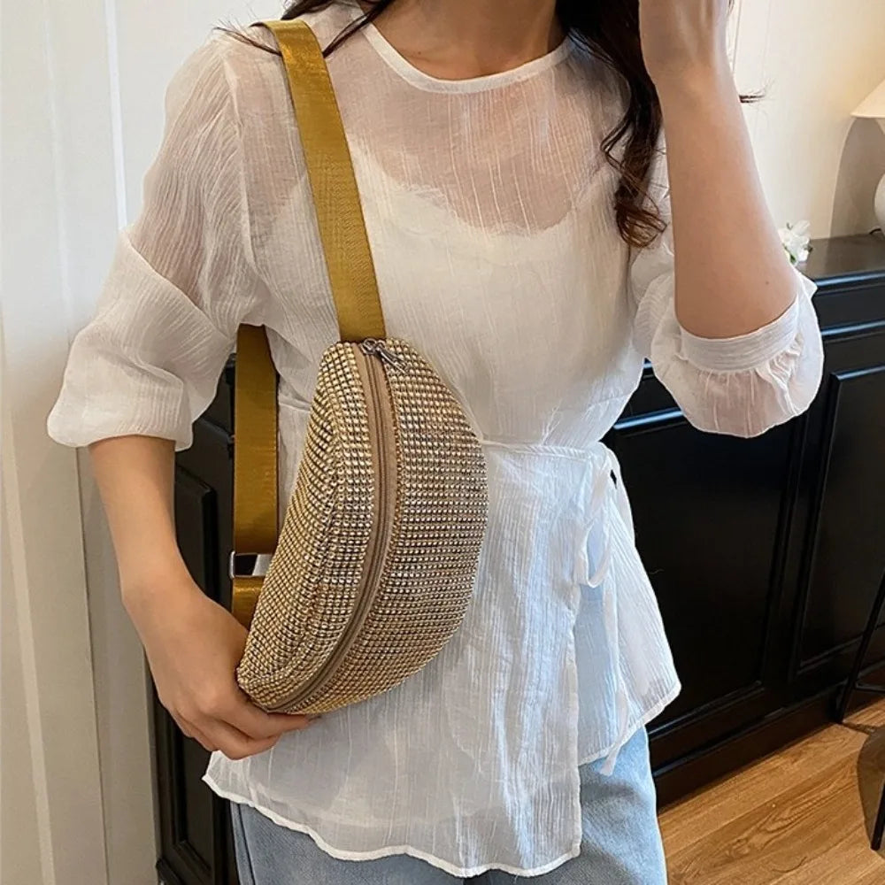 A woman models a white sheer blouse and a gold rhinestone-embellished crossbody waist bag with an adjustable strap.