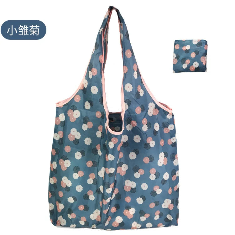 A reusable eco tote shopping bag in blue and pink floral pattern.