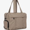 A beige large capacity women's travel duffle bag with padded compartments and carrying handles.