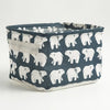 A dark blue fabric storage basket with white bear print and handles.