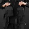 A person is holding a black Oxford chest bag with a strap, designed as a lightweight travel phone pouch.