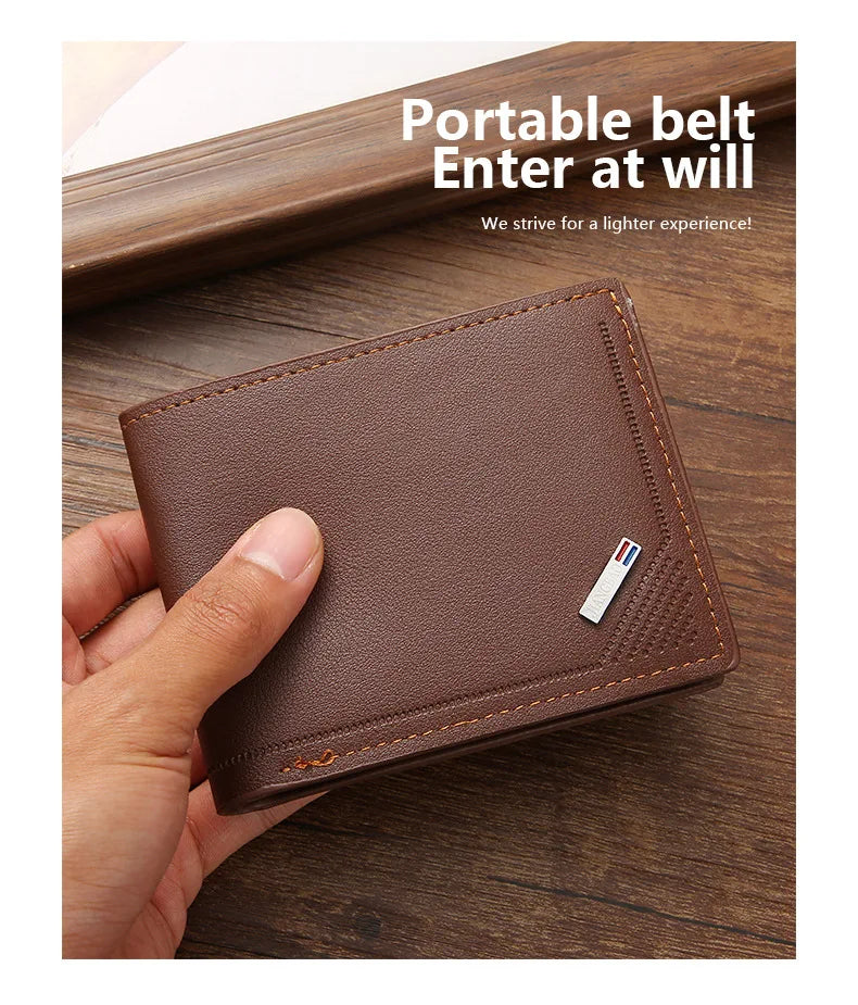 A brown leather belt wallet with a money clip is held in a hand on a wooden surface.