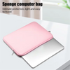A pink sponge computer bag protecting a silver laptop, shown open on a white surface.
