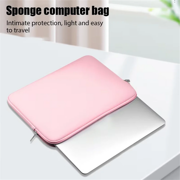 A pink sponge computer bag protecting a silver laptop, shown open on a white surface.