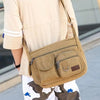 A person is wearing a tan canvas tool bag with multiple pockets and white stripes, paired with light-colored pants.