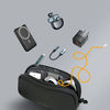 A black travel electronics organizer pouch containing various gadgets like headphones and cables.