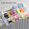 Five random colored adjustable luggage straps with buckles displayed on a white suitcase.