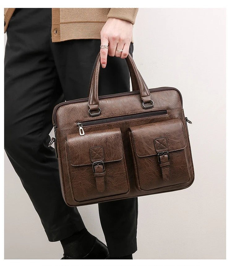 A brown men's PU leather business briefcase bag being held by a person wearing black pants and a beige jacket.