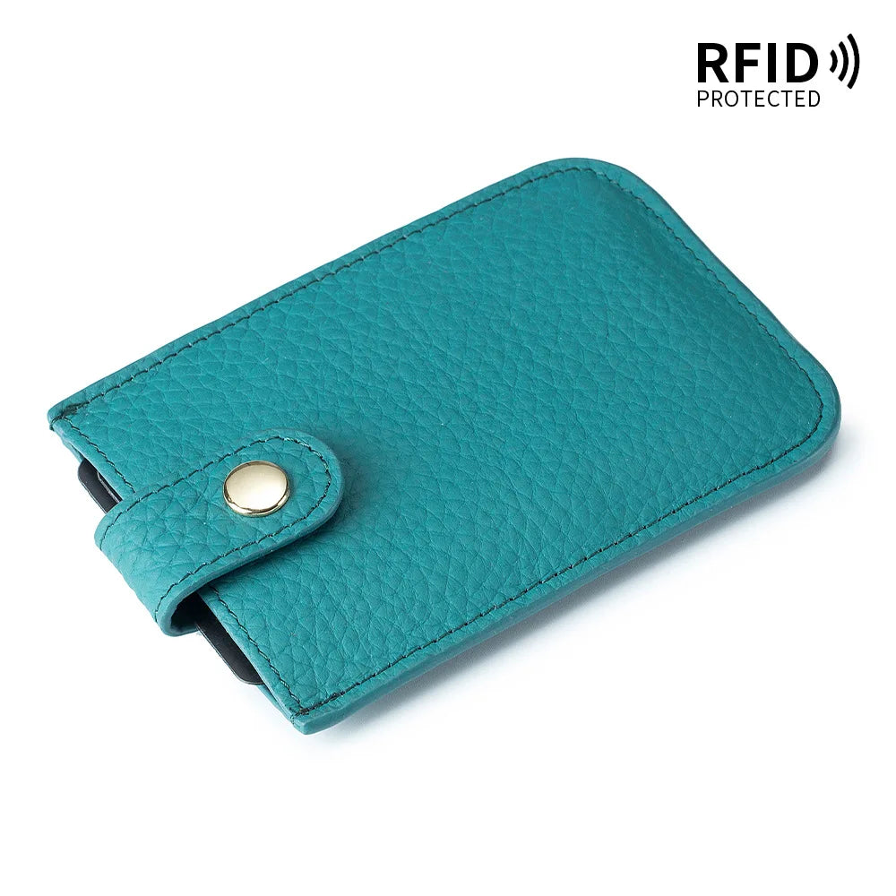 A teal genuine leather slim card holder with a stitched closure and RFID protection label.