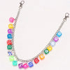 A silver chain necklace featuring colorful dice charms in various shades of pink, blue, green, and yellow.