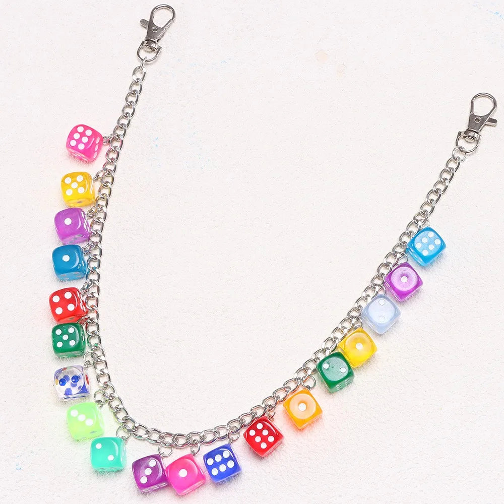 A silver chain necklace featuring colorful dice charms in various shades of pink, blue, green, and yellow.