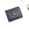 A dark blue leather card holder wallet with a zipper and coin pocket shown from above.