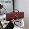 A burgundy crocodile-embossed PU leather clutch bag is being held by a person against a white background.