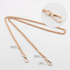 A gold-colored adjustable metal chain strap with a lobster clasp is shown against a white background.