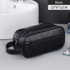 Black men's premium leather travel cosmetic bag shown on a gray surface.