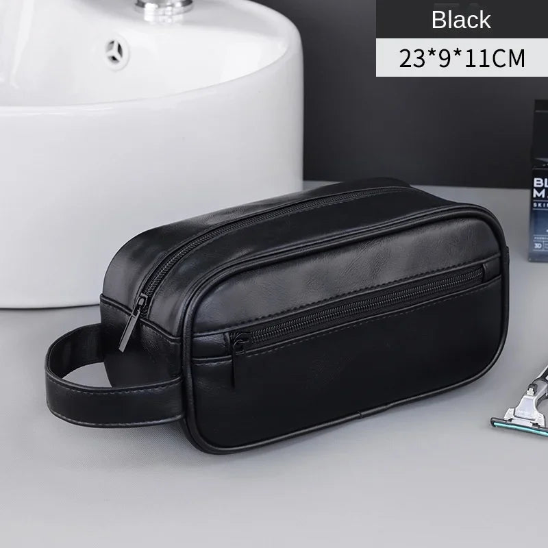 Black men's premium leather travel cosmetic bag shown on a gray surface.