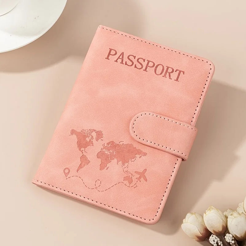 A pink passport wallet with a world map design is shown on a light background.