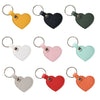 A collection of colorful leather heart keychains in various shades including yellow, black, green, white, pink, mint, gray, r
