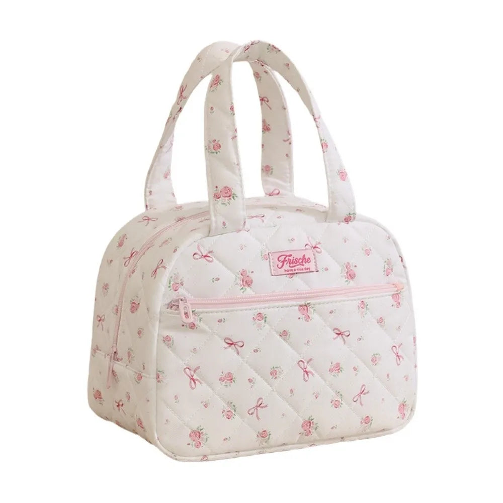A pink quilted insulated lunch tote bag with white fabric and pink trim.