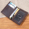 A brown genuine leather bifold card holder displaying various cards and a clear slot.
