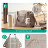 A beige expandable lightweight travel duffle bag with a D-ring and smooth zippers shown on a wooden surface.