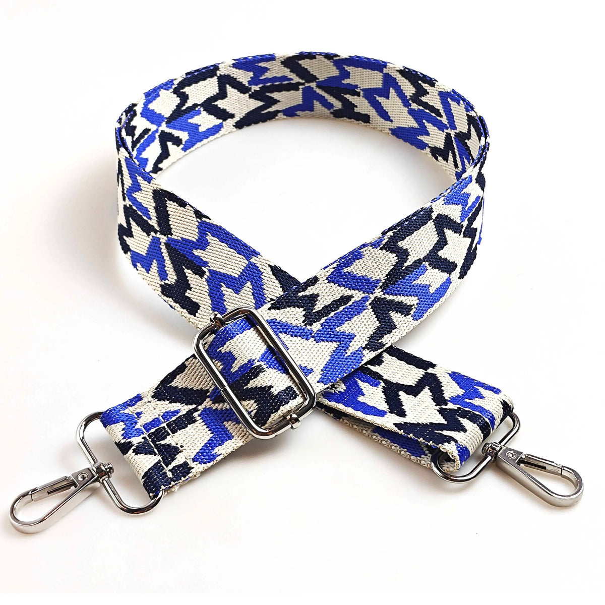 A navy blue and cream patterned jacquard strap for an adjustable wide crossbody bag.