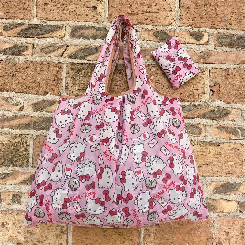 A pink and white patterned reusable shopping bag with a handle is displayed against a brick background.