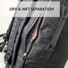 Close-up of a black waterproof travel gym backpack showing a dry and wet separation feature.