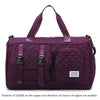 A purple nylon travel duffle bag with a quilted pattern and fabric handles.