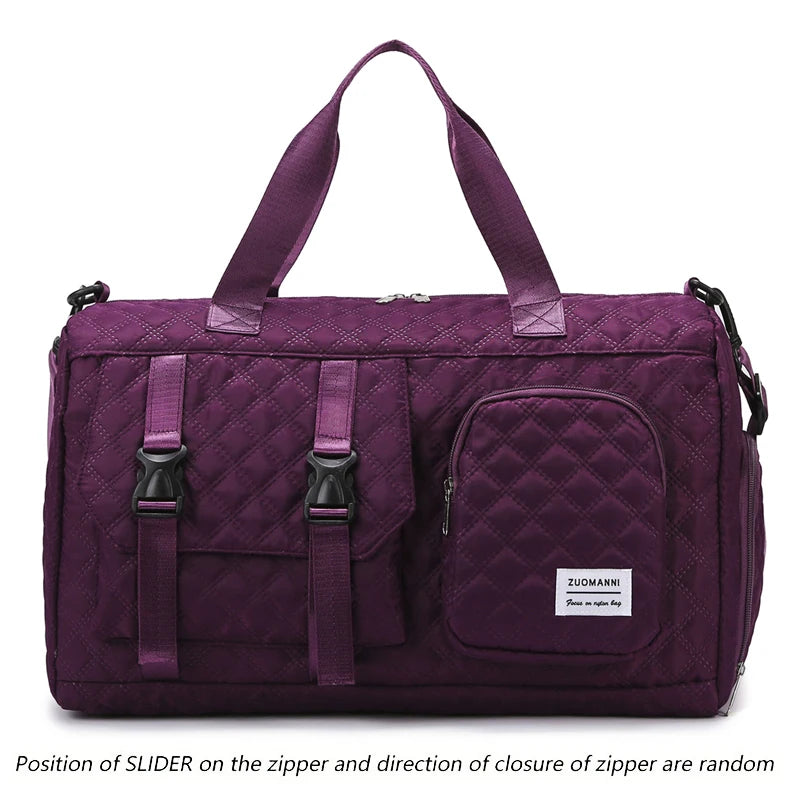 A purple nylon travel duffle bag with a quilted pattern and fabric handles.