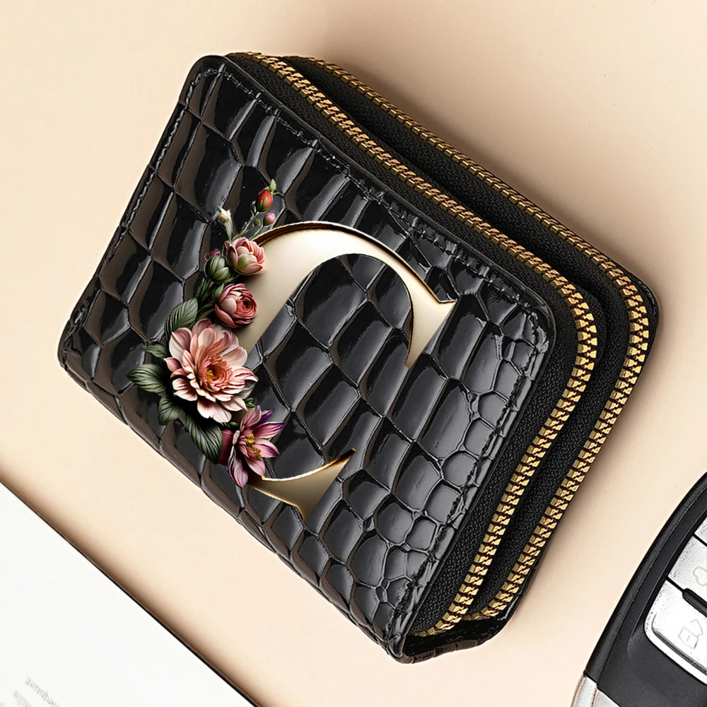 A black PU leather double-zip clutch wallet with a gold accent and a cartoon print design.