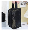 A black mesh transparent makeup storage bag with a black strap is shown against a light background.