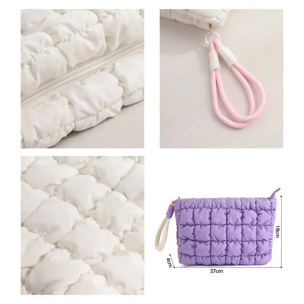 A purple quilted puffer makeup bag with a white strap and zipper, shown next to a white fabric item.