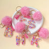 Pink fuzzy initial letter keychain charms in resin for bags and backpacks
