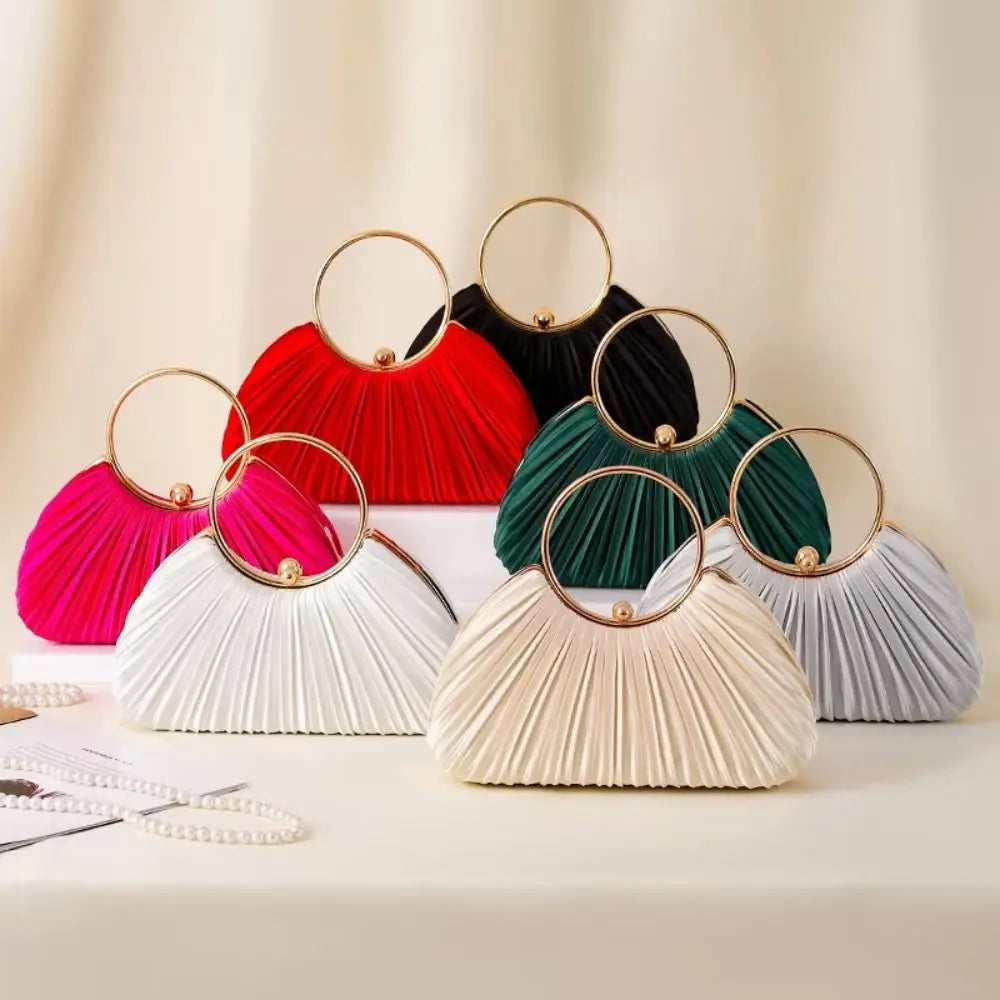 A collection of elegant satin pleated evening clutch bags in various shades including red, black, pink, and green.