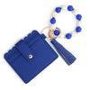 A silicone bead and leather card wallet featuring blue and white beads and a navy blue leather sleeve.