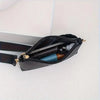 A black quilted chain crossbody bag is shown open, revealing a pen and an eyeliner pencil.