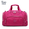 A magenta nylon travel duffle bag with pink straps and silver zippers.
