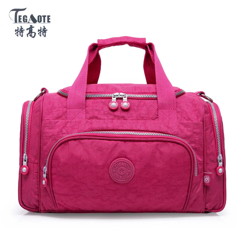 A magenta nylon travel duffle bag with pink straps and silver zippers.