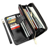 A black wax leather long wallet with a zipper and wrist strap, showing various cards and cash inside.