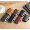 A collection of premium double layer ID card holder wallets in various leather colors and textures arranged on a wooden surfa