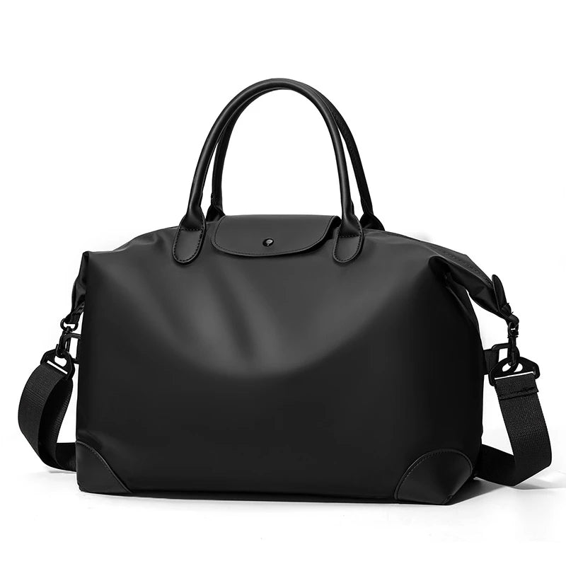 A black durable nylon travel duffle bag with leather handles and straps.