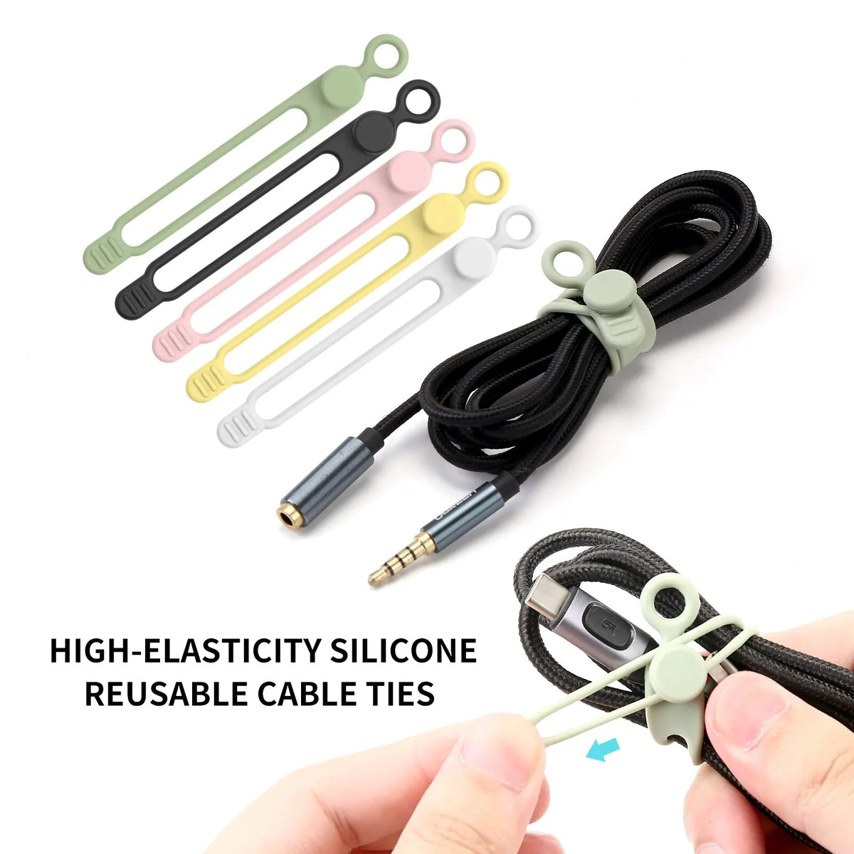 A collection of high-elasticity silicone reusable cable ties in various colors and a black cord organizer being held by a han